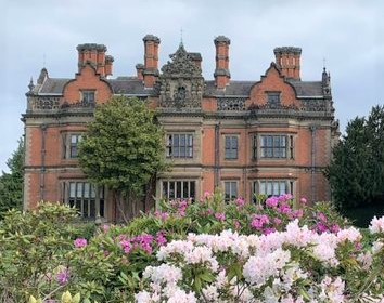 Beaumanor Hall with flowers in the foreground.